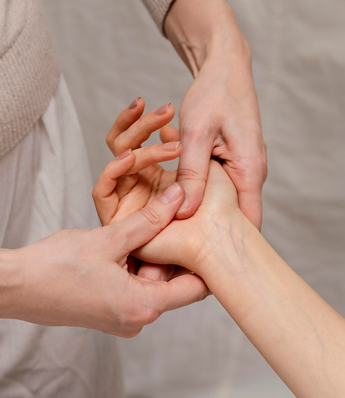 close-up-therapist-massaging-palm.jpg