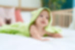 adorable-toddler-lying-bed-covering-with-funny-towel-bedroom.jpg