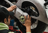 man-fixing-motorcycle-modern-workshop.jpg