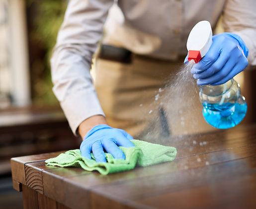 closeup-waitress-disinfecting-tables-outdoor-cafe.jpg