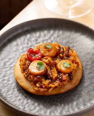 This image contains a photo of a dish named 'danthal', heart of palm, doli roti