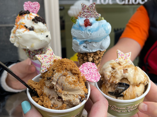 tubs of ice cream overflowing with toppings