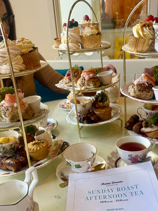 Delightful tiered tray of assorted food and tea cups on a decorated table Activities in Harrogate
