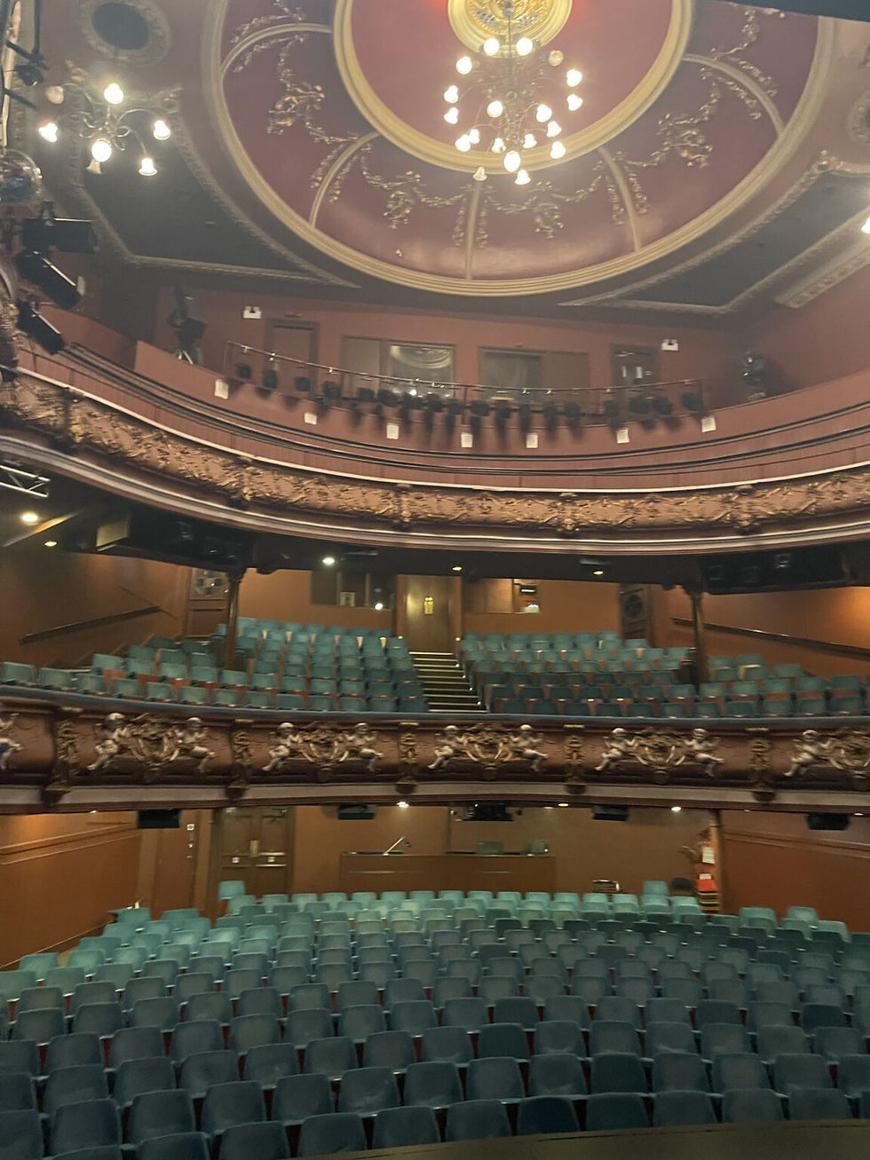 Inside view of a theater showing seating and upper level balconies.