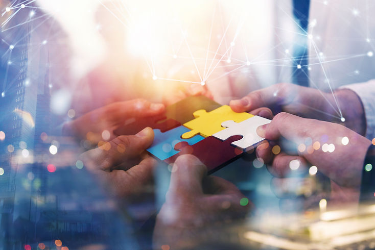 Business people join puzzle pieces in office Concept of teamwork and partnership double ex