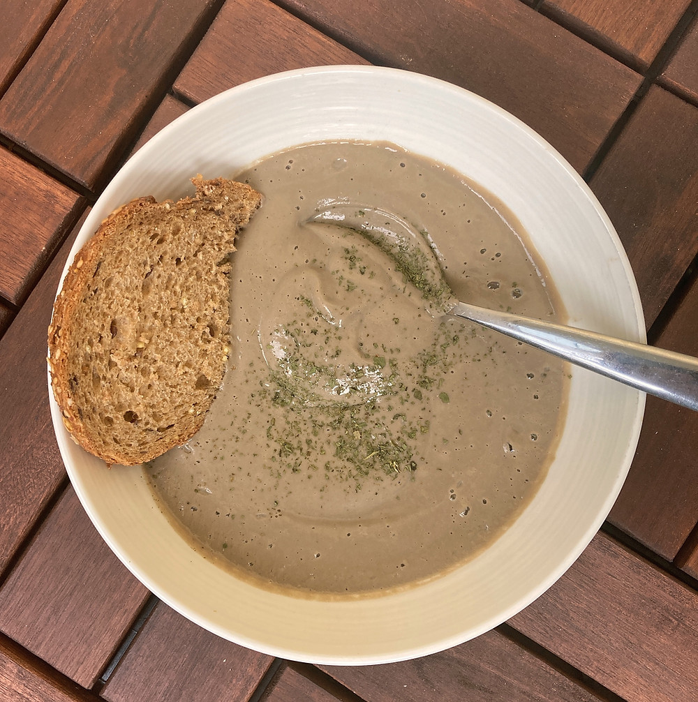mushroom soup in bowl with bread