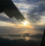 plane wing and peninsula during sunrise