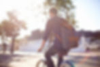 man riding bike with backpack