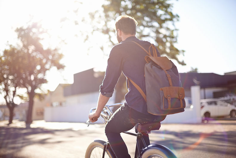man riding bike with backpack