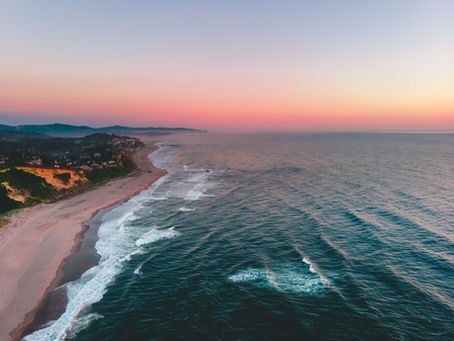 A stunning aerial shot of Lincoln City, Oregon's coastline sunset. Photo by Eric Sanman.