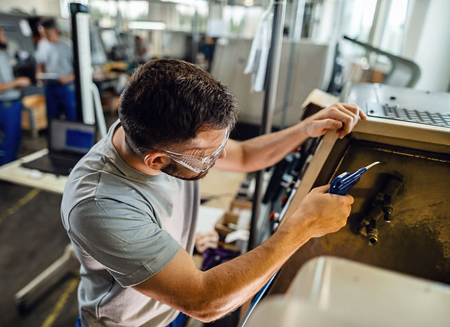 young-manual-worker-working-industrial-machine-factory-plant_edited.jpg