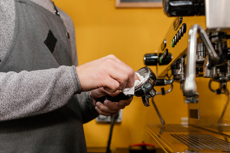side-view-male-barista-with-apron-cleaning-professional-coffee-machine.jpg