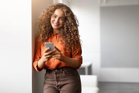 woman-with-phone-smiling-modern-setting.jpg