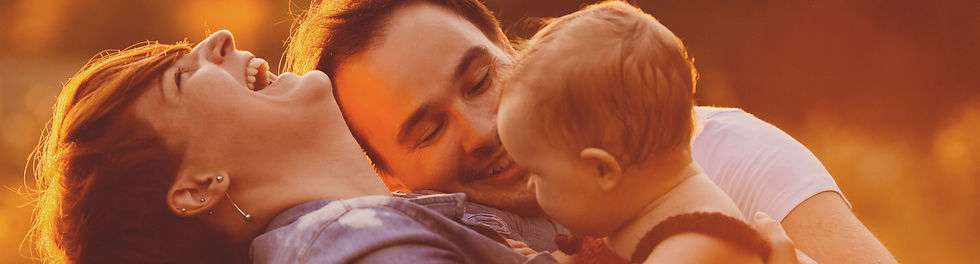 sunset-lights-shine-kissing-parents-their-little-daughter_edited.jpg
