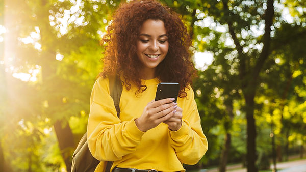 beautiful-young-cheerful-woman-spending-good-time-park-texting-mobile-phone.jpg