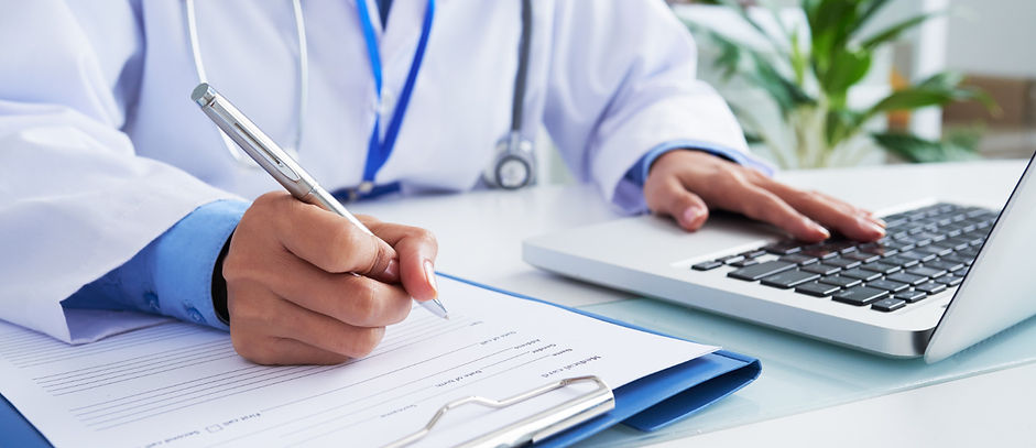 hands-unrecognizable-female-doctor-writing-form-typing-laptop-keyboard.jpg