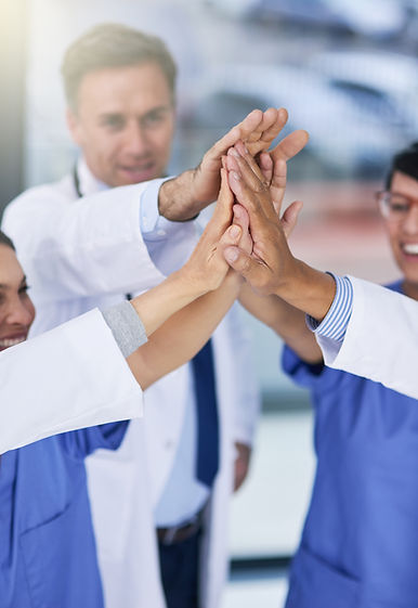 success-is-best-when-achieved-as-team-closeup-shot-medical-practitioners-giving-each-other