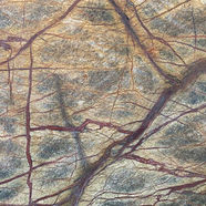 Granite countertop with orange variations and rust red veining.