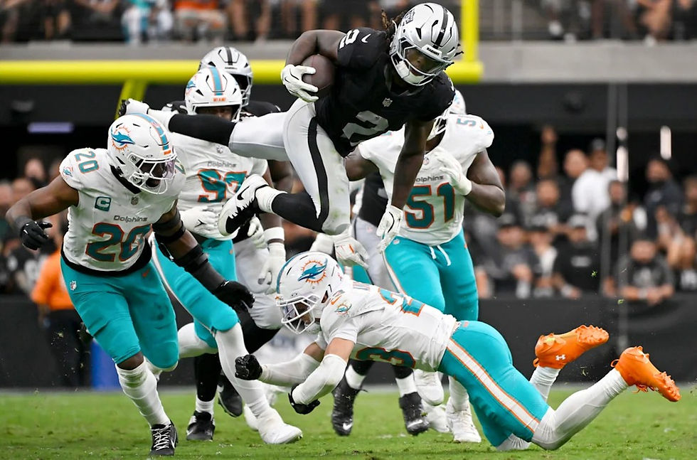 Ashton Jeanty leaping over Dolphins defenders, (David Becker, https://www.nfl.com/photos/top-10-photos-from-week-1-of-the-2026-season#d5633430-daa3-461f-b7a3-85694abdb0c4)