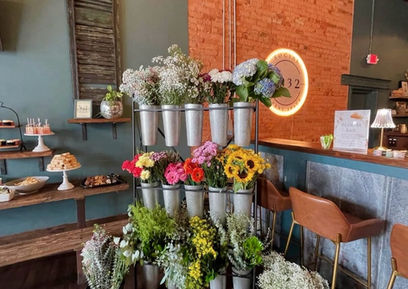 Fresh floral arrangements and event styling near the bar at Social 1832 event venue.
