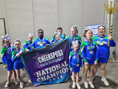 Special needs cheer team Kings and Queens from Stingray All-Stars South Atlanta in Griffin celebrating as National Champions at CHEERSPORT Nationals 2026, holding banner and wearing matching uniforms.