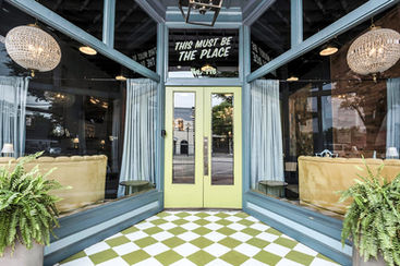 Front entrance and window seating area at Social 1832 venue.