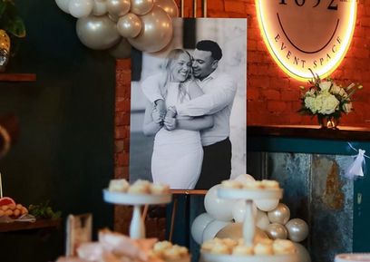 Styled celebration display with balloons and custom décor inside Social 1832 event space.