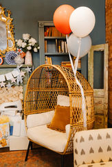 Decorative seating and balloon styling inside Social 1832 venue.