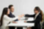 a photo of two people from HR interviewing a candidate