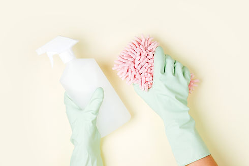 Female hands cleaning on pale yellow bac