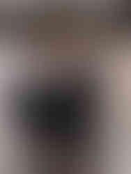 Groom and boy child smiling together in their matching suits