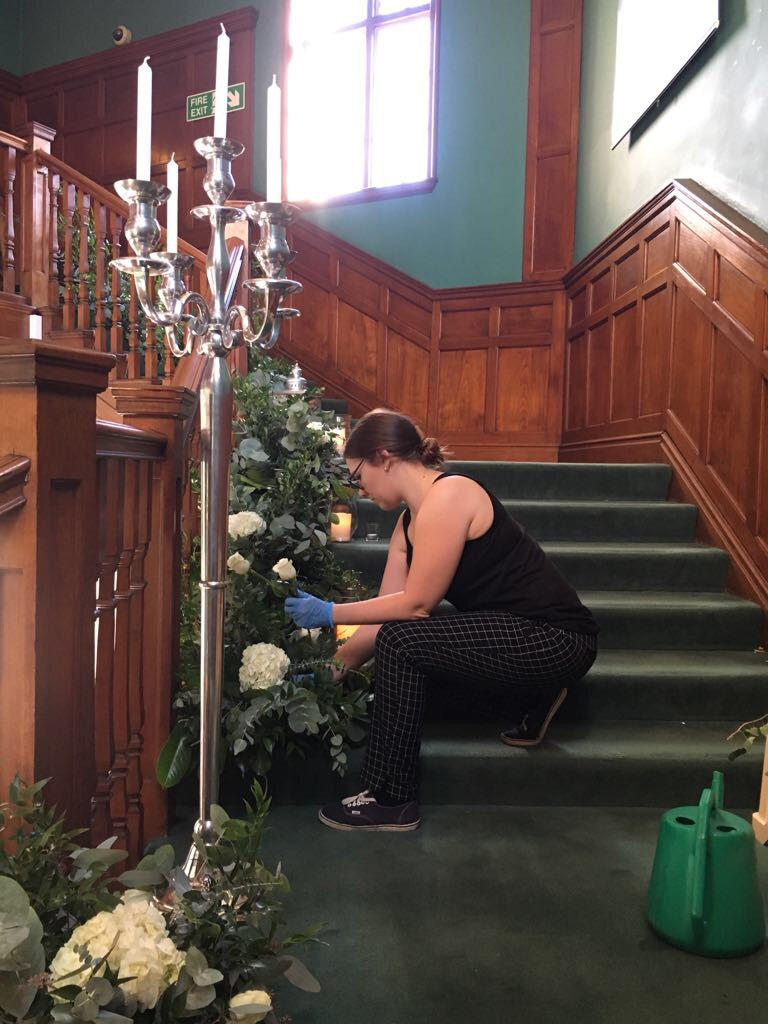 setting up a luxury floral staircase arrangement