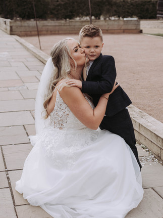 Bride kissing child on the cheek