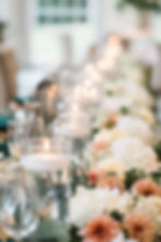 wedding top table adorned with fresh flowers and floating candles