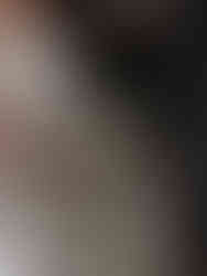 Bride and groom together with focus on bride's white floral bouquet