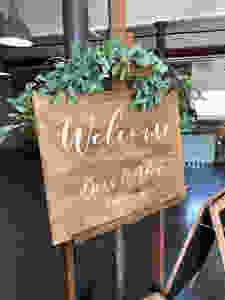 wooden rustic welcome sign for wedding at the west mill venue