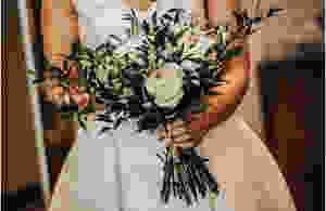 bridal bouquet with white flowers and dark greens