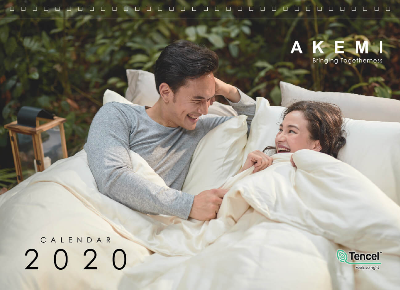 Akemi 2020 calendar cover with a couple lying on a bed with smile