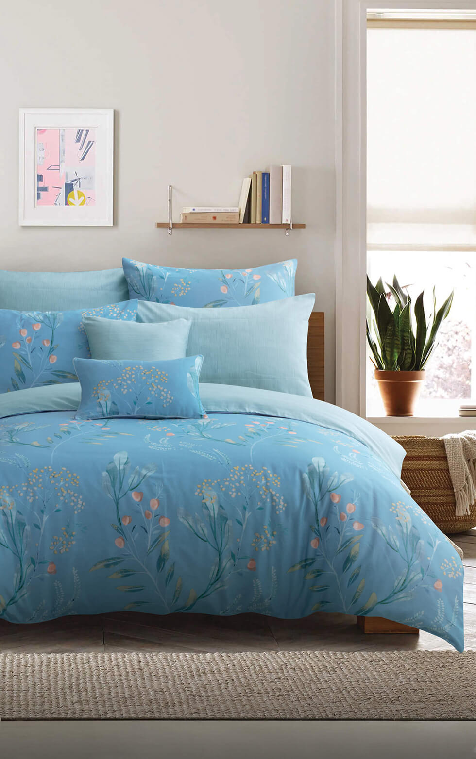 blue bed and pillow in a modern room with a plant at the bedside table