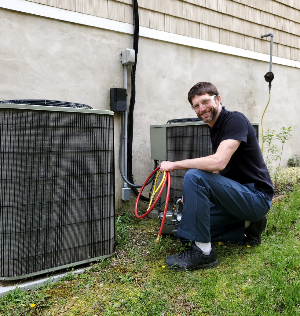 Craig Migliaccio, owner of AC Service Tech, servicing an outdoor AC unit