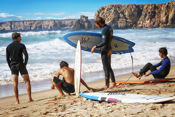 Group of surfers getting ready on the beach during a surf and wellness retreat in Costa Rica