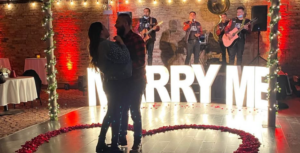 Couple Dancing at Engagement Proposal with Live Band at Chicago Theater Works. Showcasing how the venue space has been used in the past.