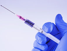 Syringe in gloved hand