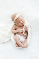 Posed newborn baby girl with studio toy prop in Barnsley photography studio