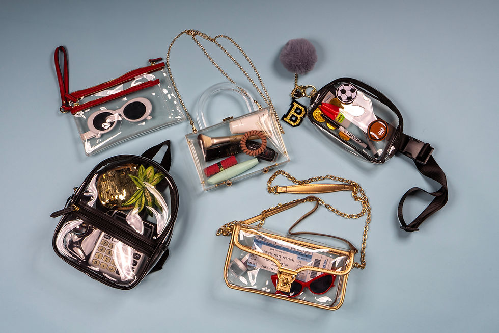 clear stadium-approved bags filled with game day essentials like team-color pouches, sunglasses, snacks, keychains, and personal items—highlighting the 2026 clear bag trend as a functional and fashionable game day accessory.