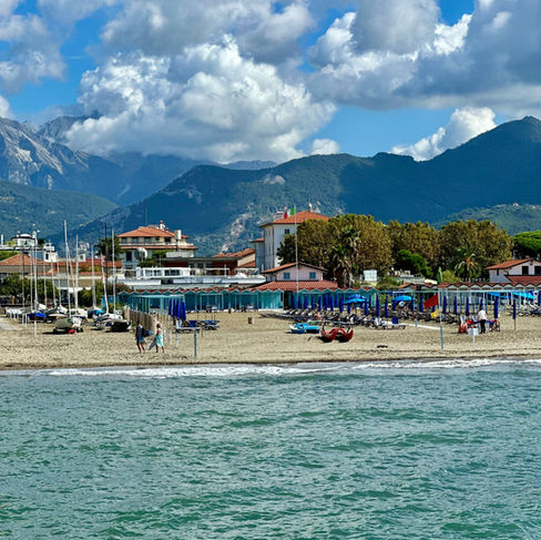 The beautiful beach at Forte dei Marmi with the mountains in the background