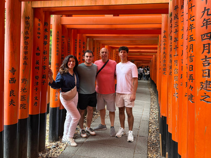 Family at the iconic torii gates of Fushimi Inari Shrine, Japan