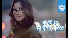 戴著粗框眼鏡的鄭秀文微笑望向鏡頭，身穿綠色外套，背景為柔和的街燈光影，畫面溫暖且富情感。