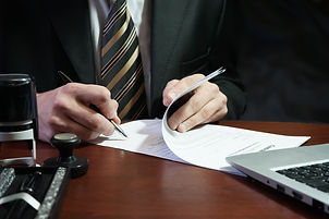 A businessman puts his signature on the