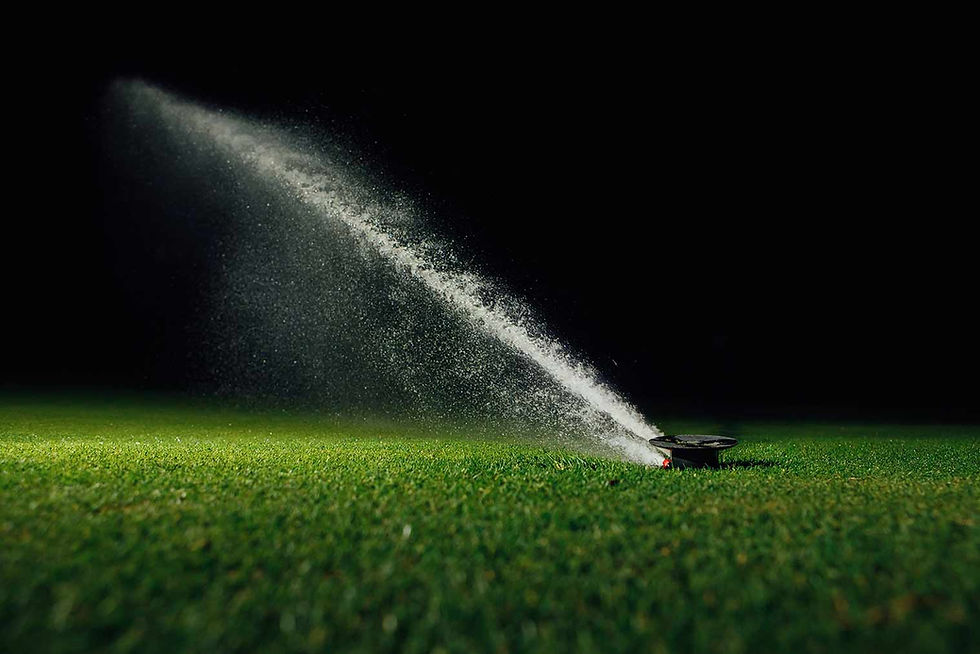 66214607217234a030655cfc_automatic sprinkler watering a lawn at night.jpg